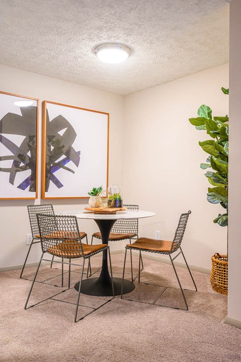 a dining room with a table and chairs at Atria at Crabtree Valley, NC 27612